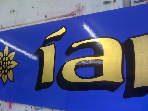 Hand painted Gold leaf lettering with a black block shade and outline