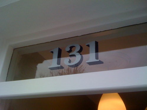 House numbers reverse painted onto glass door fanlight
