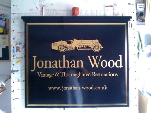 Large timber and gold leaf signwritten hanging sign with Car design