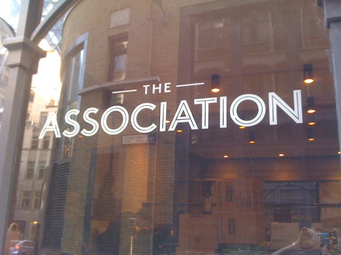 Glass signwriting at Association Coffee in London