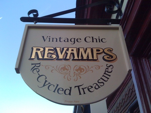 Gold leaf lettering on a shop swinging hanging sign