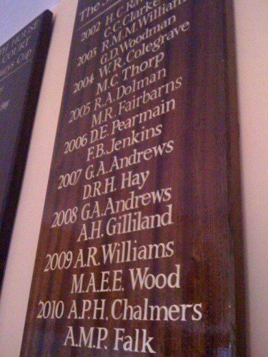 Gold leaf names on a mahogany honours roll board