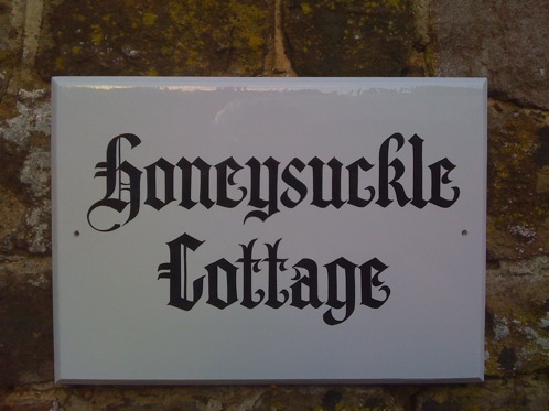 Hand painted timber house sign in Old English style painted  lettering