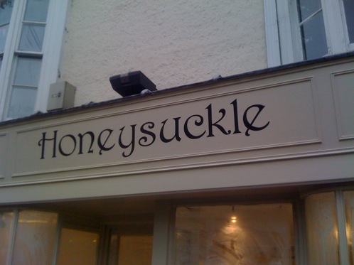 Traditionally hand painted signwritten shop sign in Dorking Surrey