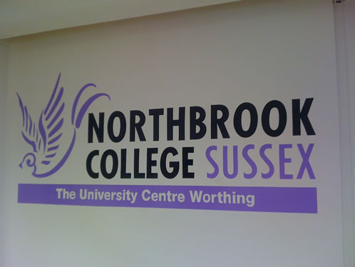 Mural logo on the wall inside Northbrook College, Worthing