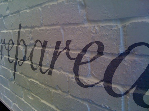 Hand painted lettering to rough brick surfaces