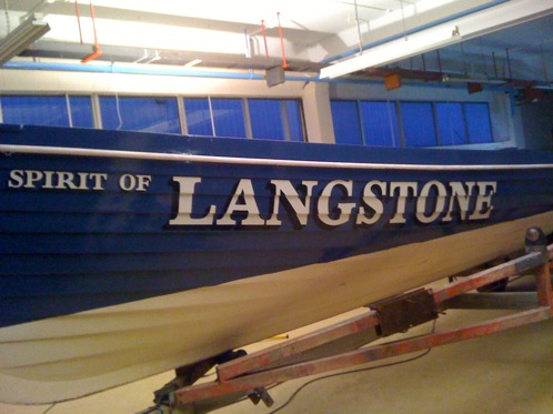 Hand painted traditional signwriting on a Victorian wooden rowing gig boat