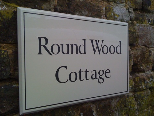 Hand painted timber house sign in brush painted Roman style  lettering