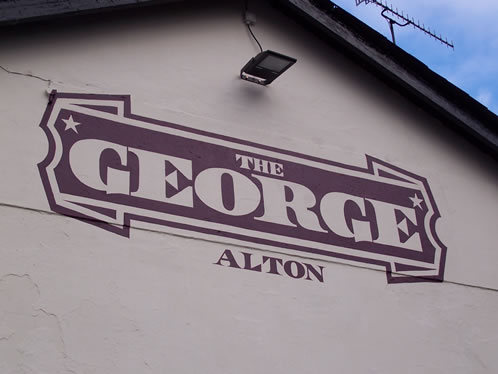 Large sign hand painted directly to a pub brick wall