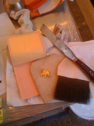 Simple tools used to apply loose gold leaf