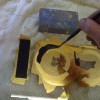 A reverse gold leaf sign on glass in progress