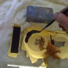A reverse gold leaf sign on glass in progress