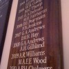 Gold leaf names on a mahogany honours roll board