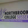 Mural logo on the wall inside Northbrook College, Worthing