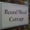 Hand painted timber house sign in brush painted Roman style  lettering