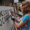 Students hand painting letters at a signwriting class