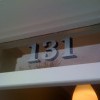House numbers reverse painted onto glass door fanlight